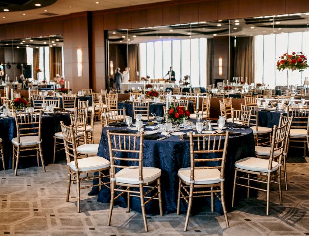 A cozy cafe or classroom-like space with people seated at tables, warm lighting, and a chalkboard or whiteboard in the background, a casual gathering.